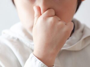 鼻をつまむ子供